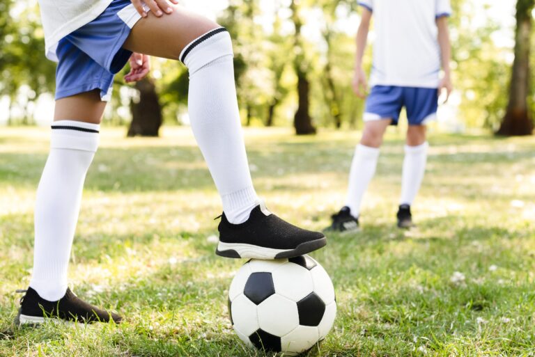 children playing together football outdoors